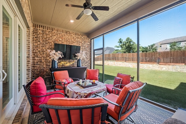 sunroom / solarium featuring ceiling fan