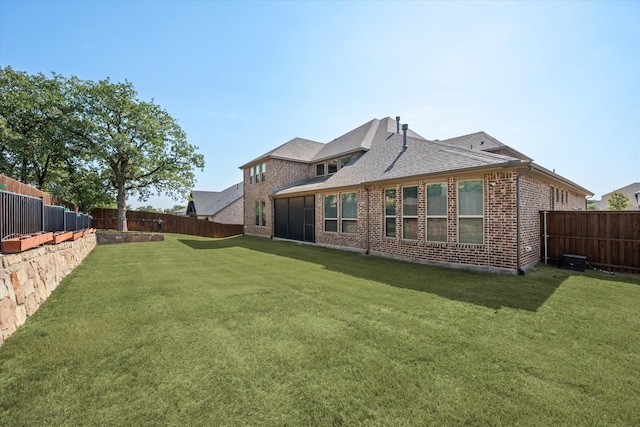 rear view of property with a lawn