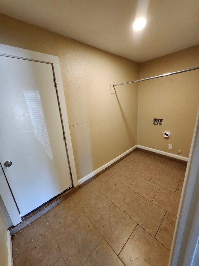 clothes washing area featuring light tile patterned flooring