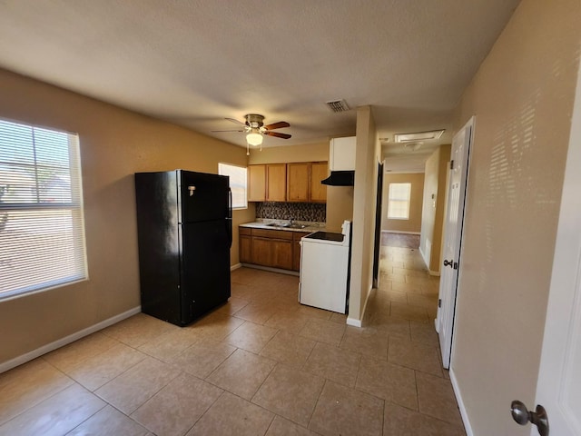 kitchen with black refrigerator, sink, tasteful backsplash, white electric range oven, and ceiling fan