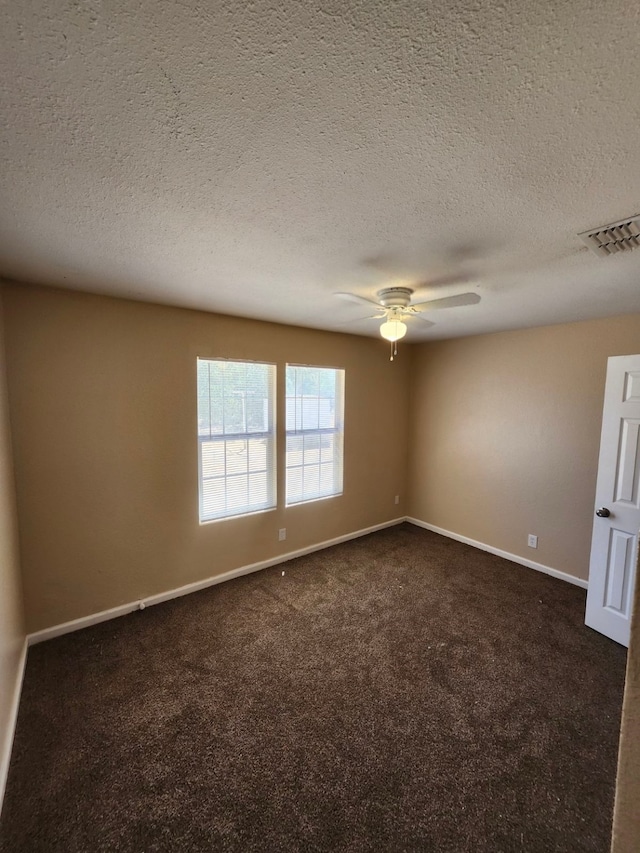 carpeted empty room with a textured ceiling and ceiling fan