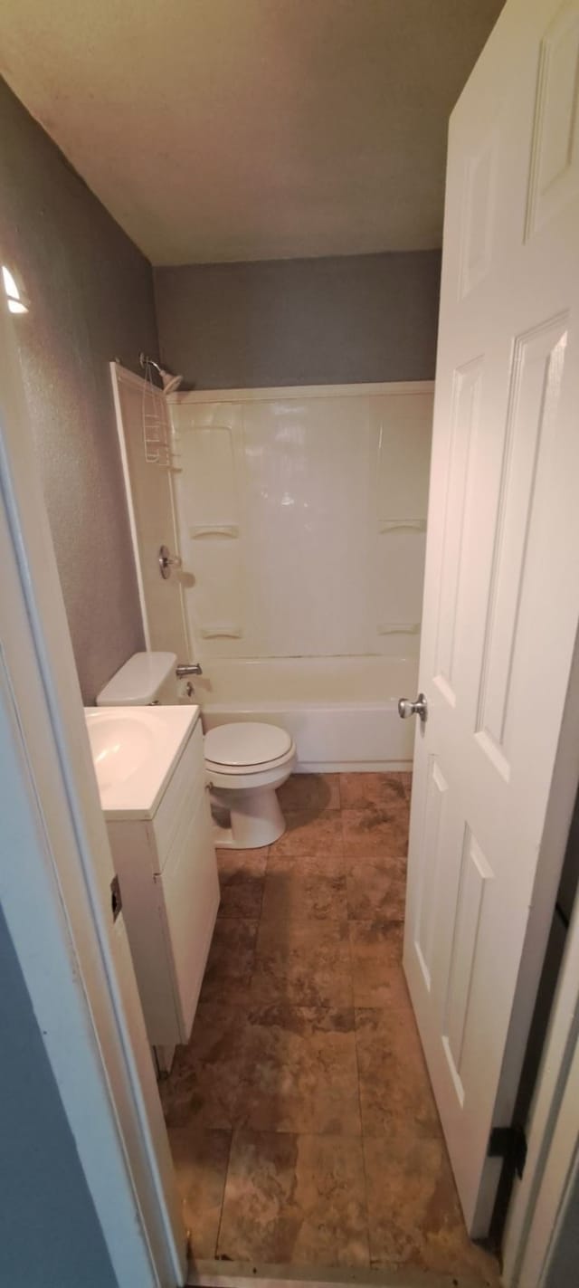 full bathroom featuring toilet, vanity, and bathing tub / shower combination