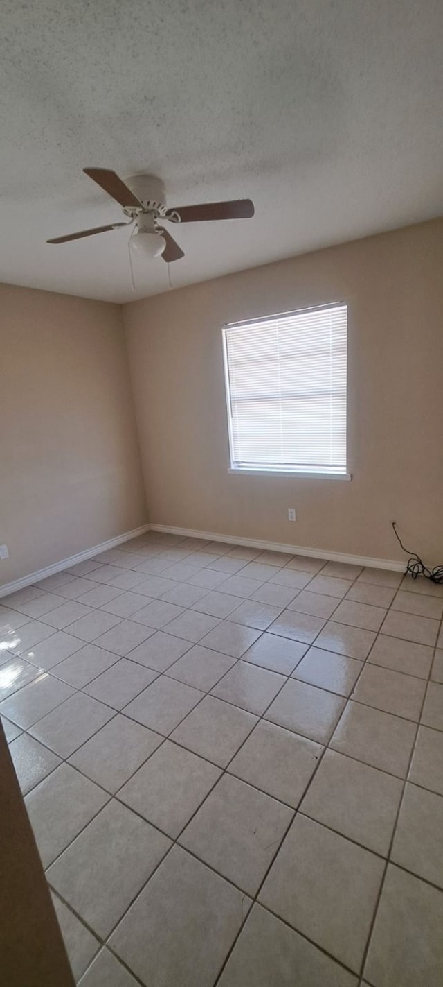 unfurnished room featuring ceiling fan, a textured ceiling, and light tile patterned flooring