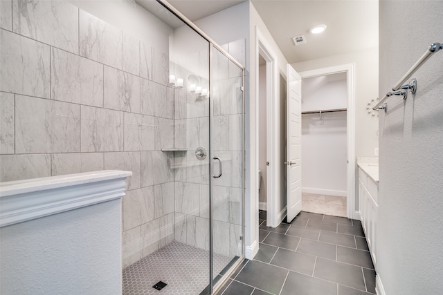 bathroom featuring vanity, tile patterned floors, and an enclosed shower