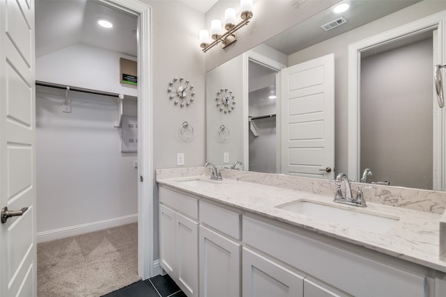 bathroom featuring vanity and vaulted ceiling