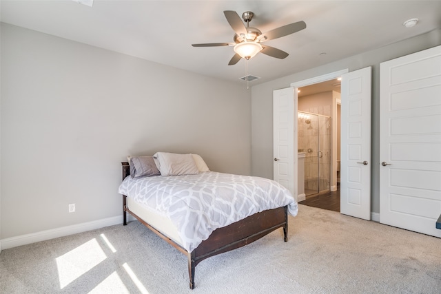 carpeted bedroom featuring ensuite bathroom and ceiling fan