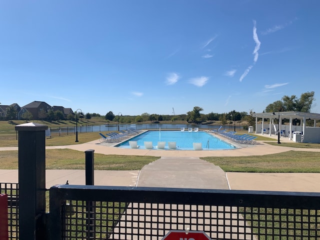 view of pool with a patio and a yard