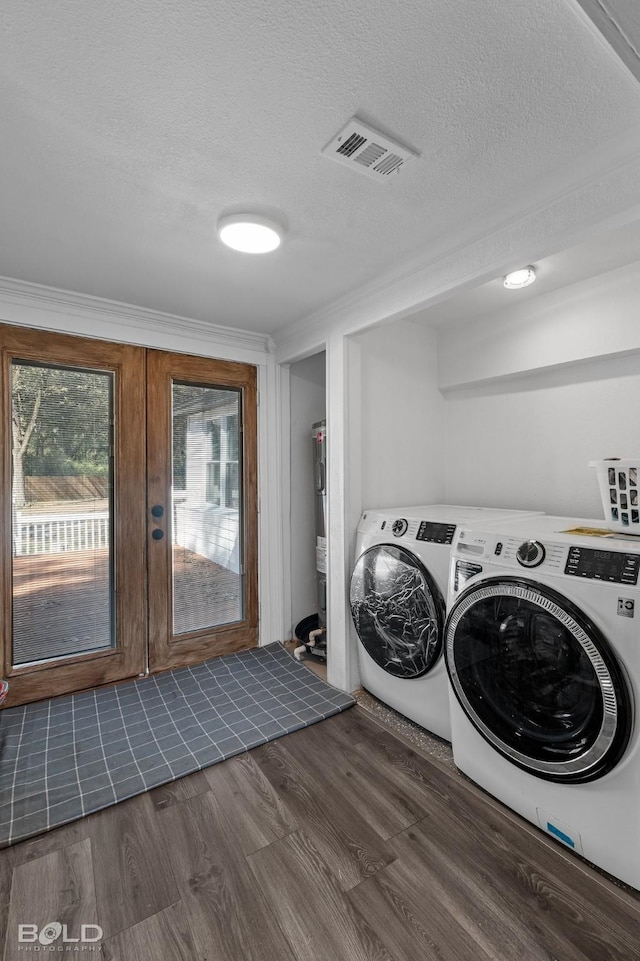 laundry area with dark wood-style floors, visible vents, a textured ceiling, laundry area, and independent washer and dryer