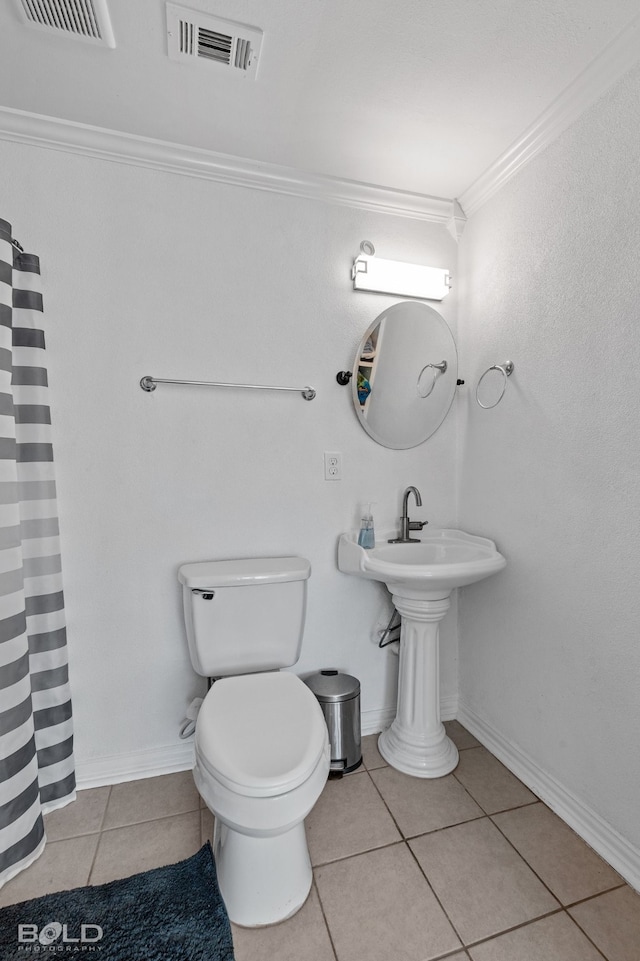 bathroom with toilet, tile patterned floors, ornamental molding, and curtained shower