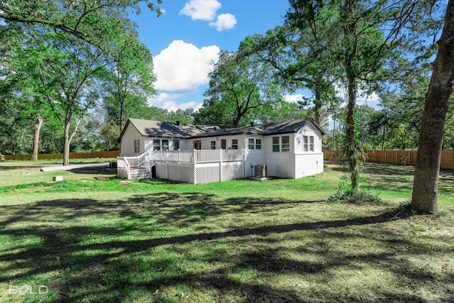 rear view of property with stairs, fence, a deck, and a lawn