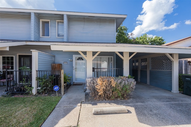 view of front of home featuring a carport and a porch