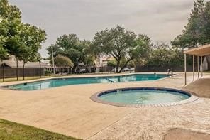 view of swimming pool featuring a patio and an in ground hot tub