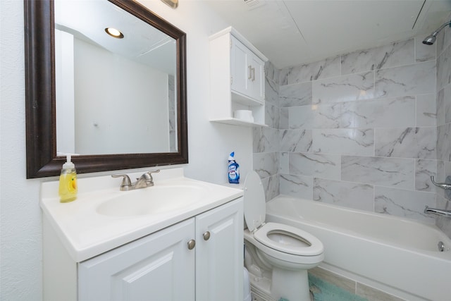 full bathroom featuring vanity, tiled shower / bath combo, and toilet