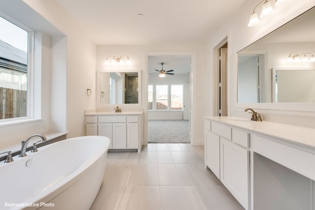 bathroom featuring vanity, tile patterned flooring, and a washtub