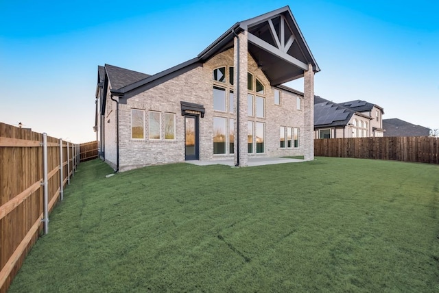 back of house with a yard and a patio area