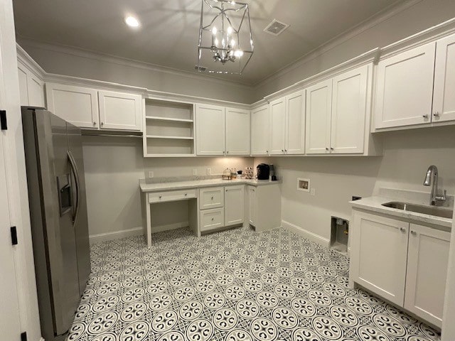 washroom featuring cabinets, washer hookup, a notable chandelier, crown molding, and sink