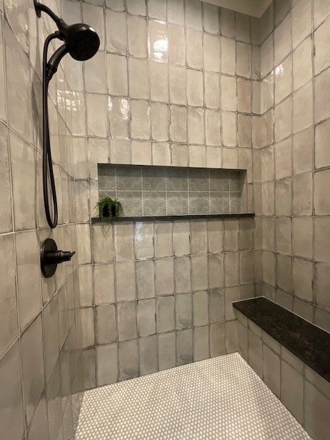 bathroom with a tile shower