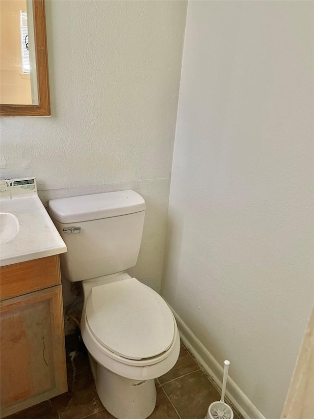 bathroom featuring toilet, vanity, and tile patterned floors