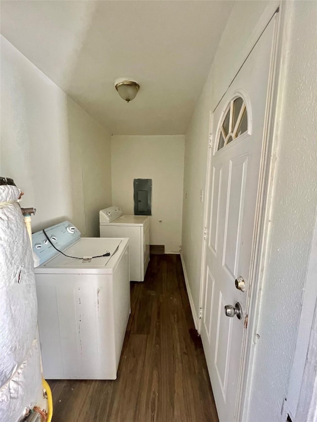 clothes washing area with electric panel, washer and clothes dryer, and dark hardwood / wood-style floors