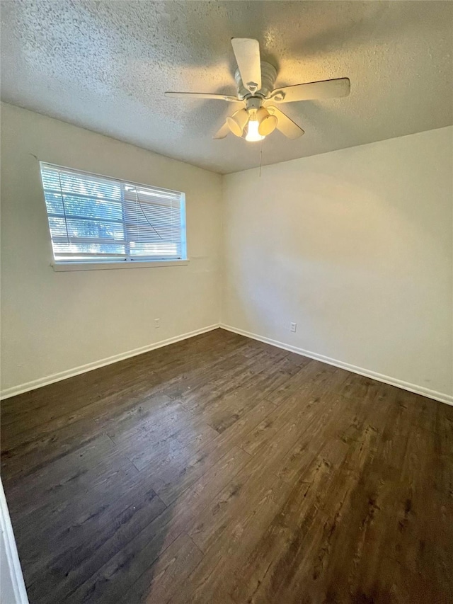 empty room with a textured ceiling, ceiling fan, and dark wood-type flooring