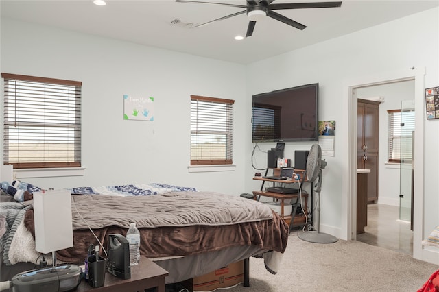 bedroom with ceiling fan and light carpet