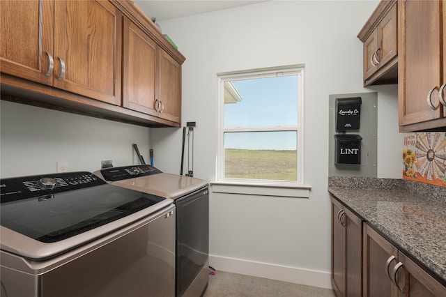 laundry area with washer and clothes dryer and cabinets