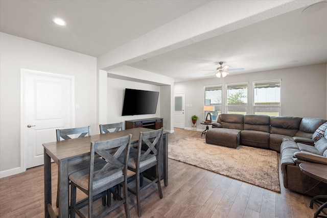 living room featuring hardwood / wood-style floors and ceiling fan