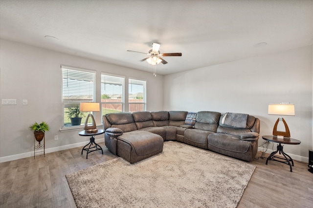 living room with light hardwood / wood-style floors and ceiling fan