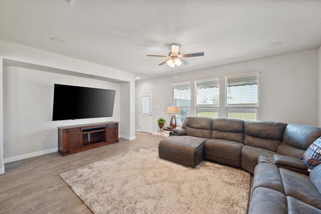 living room featuring light hardwood / wood-style floors and ceiling fan