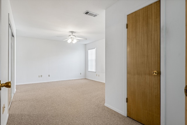 carpeted empty room with ceiling fan