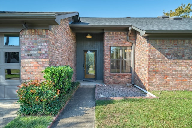 doorway to property featuring a lawn