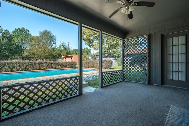 unfurnished sunroom with ceiling fan