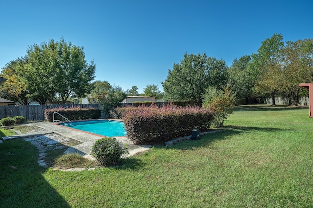 view of swimming pool with a patio and a yard