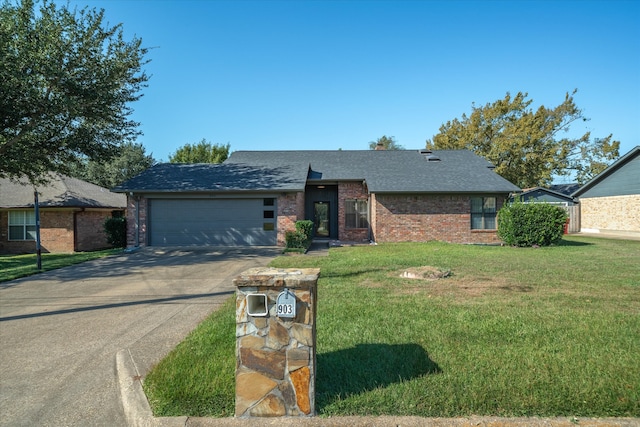 view of front facade with a front yard and a garage