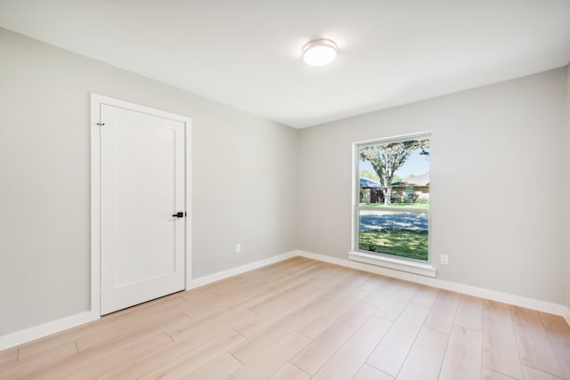 unfurnished room with light hardwood / wood-style floors