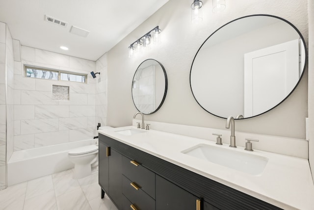 full bathroom with tiled shower / bath, vanity, and toilet