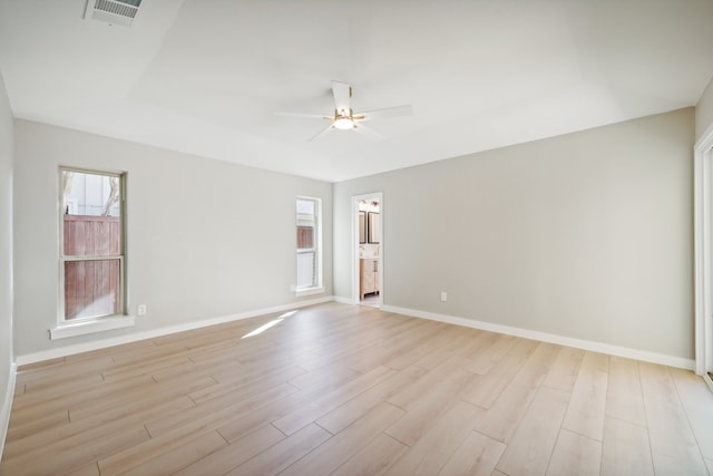 empty room featuring light hardwood / wood-style flooring, a wealth of natural light, and ceiling fan