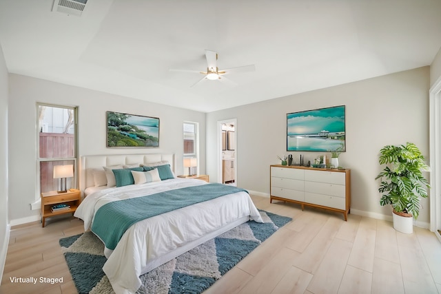 bedroom featuring ensuite bathroom, light wood-type flooring, and ceiling fan