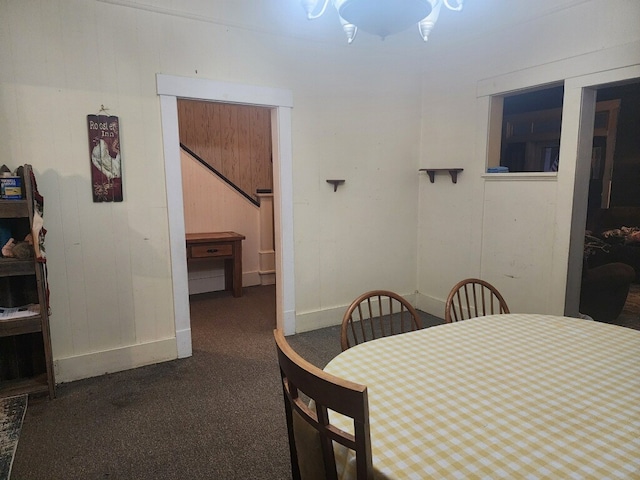 dining room featuring dark carpet