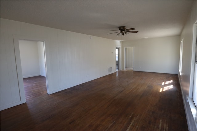 spare room featuring dark hardwood / wood-style floors, a textured ceiling, and ceiling fan