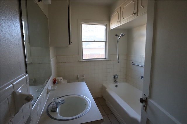 bathroom with vanity,  shower combination, tile walls, and tile patterned flooring