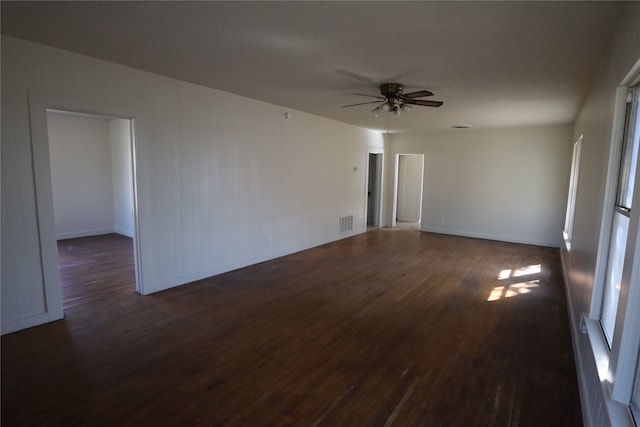 unfurnished room featuring ceiling fan, a textured ceiling, and dark hardwood / wood-style flooring