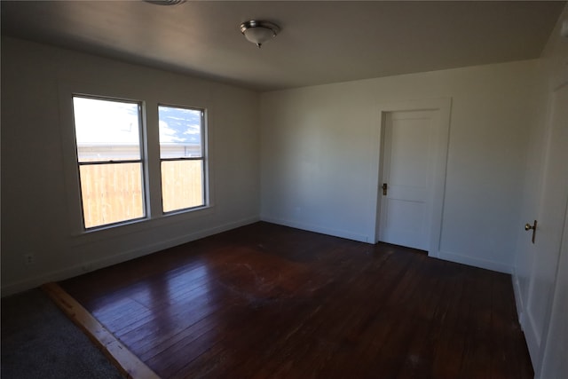 spare room with dark wood-type flooring