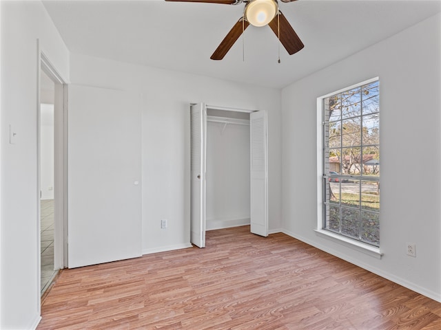 empty room featuring ceiling fan, a textured ceiling, and light wood-type flooring