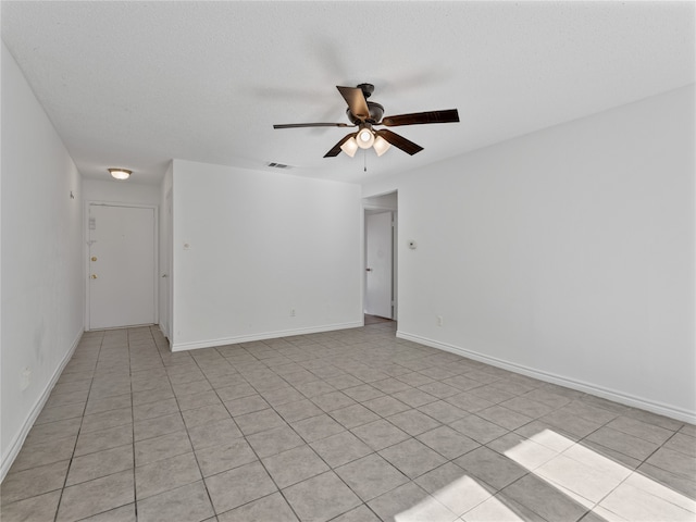 kitchen with a textured ceiling, light tile patterned flooring, and sink