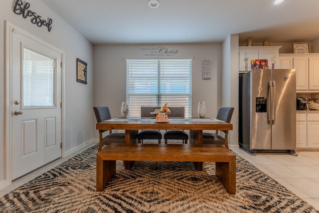 dining space featuring light tile patterned flooring