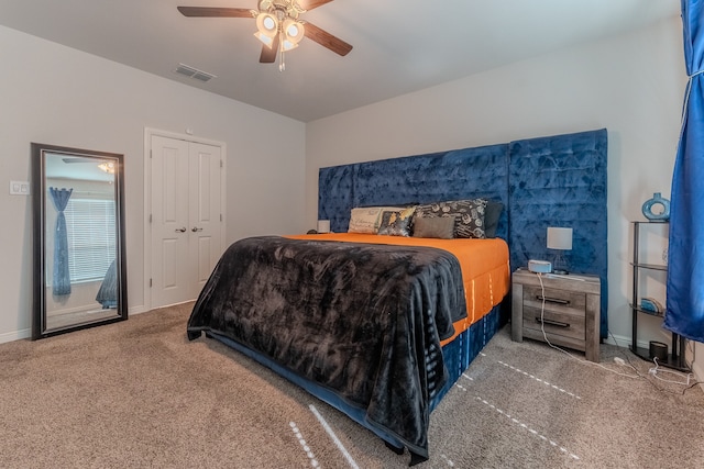 carpeted bedroom with a closet and ceiling fan