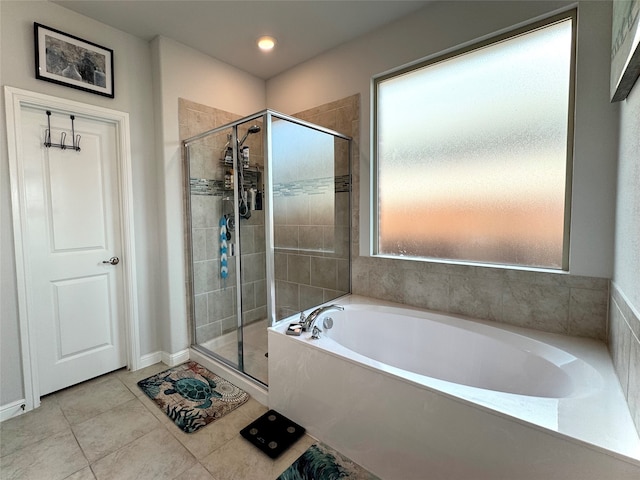 bathroom with tile patterned flooring, shower with separate bathtub, and plenty of natural light