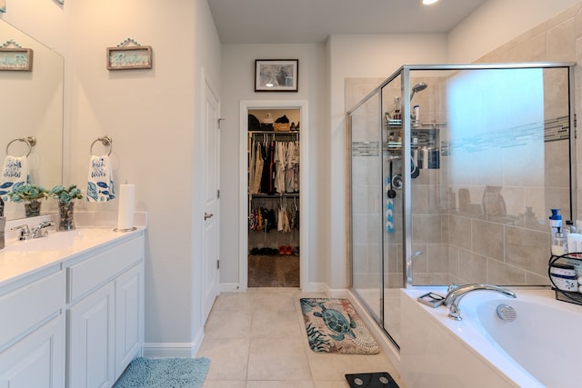 bathroom featuring tile patterned floors, vanity, and shower with separate bathtub