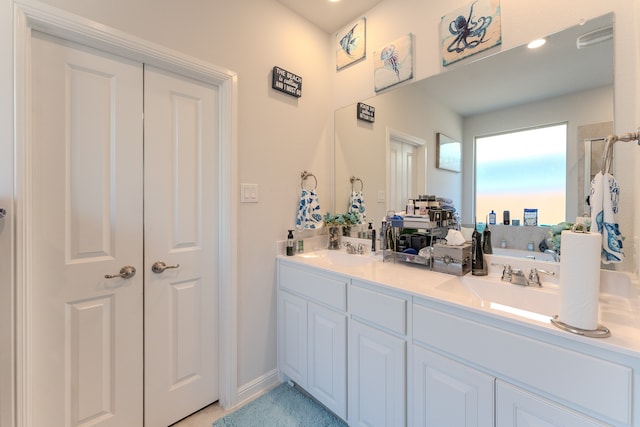 bathroom with vanity and a shower with door